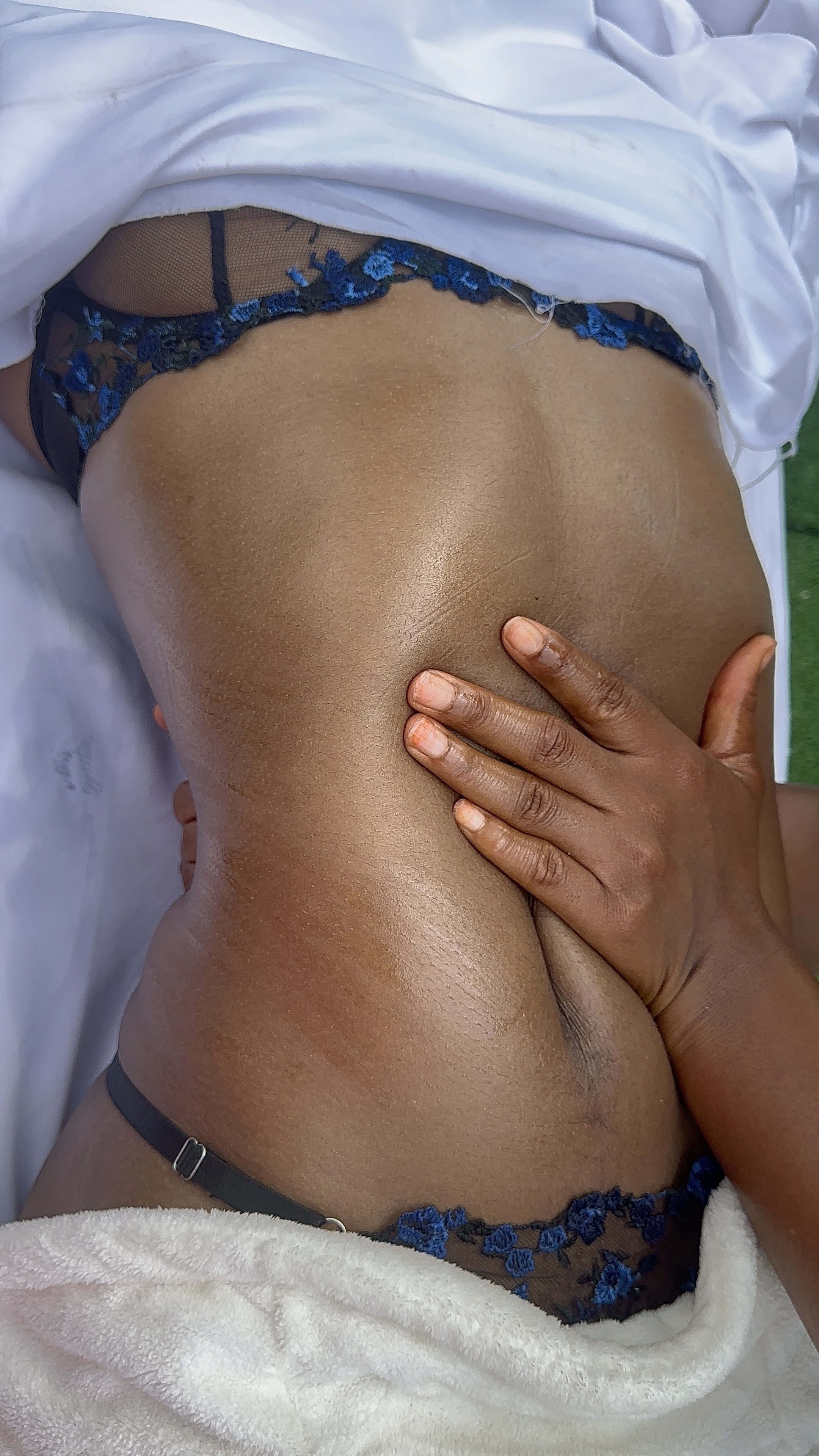 Therapist hands working across the back during a massage